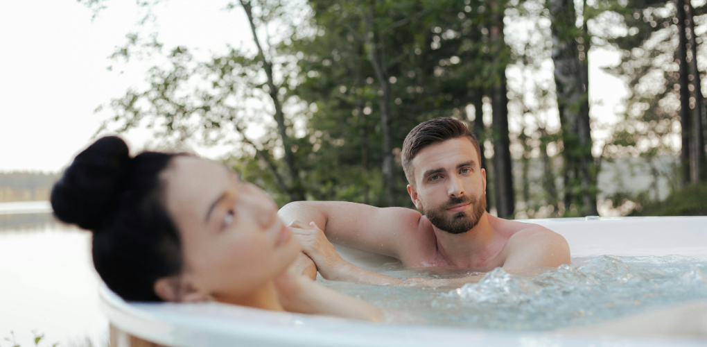couple relaxing in hot tub outdoors