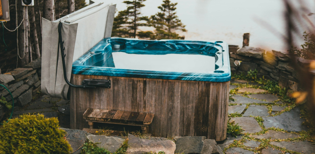 blue outdoor hot tub with lid on patio